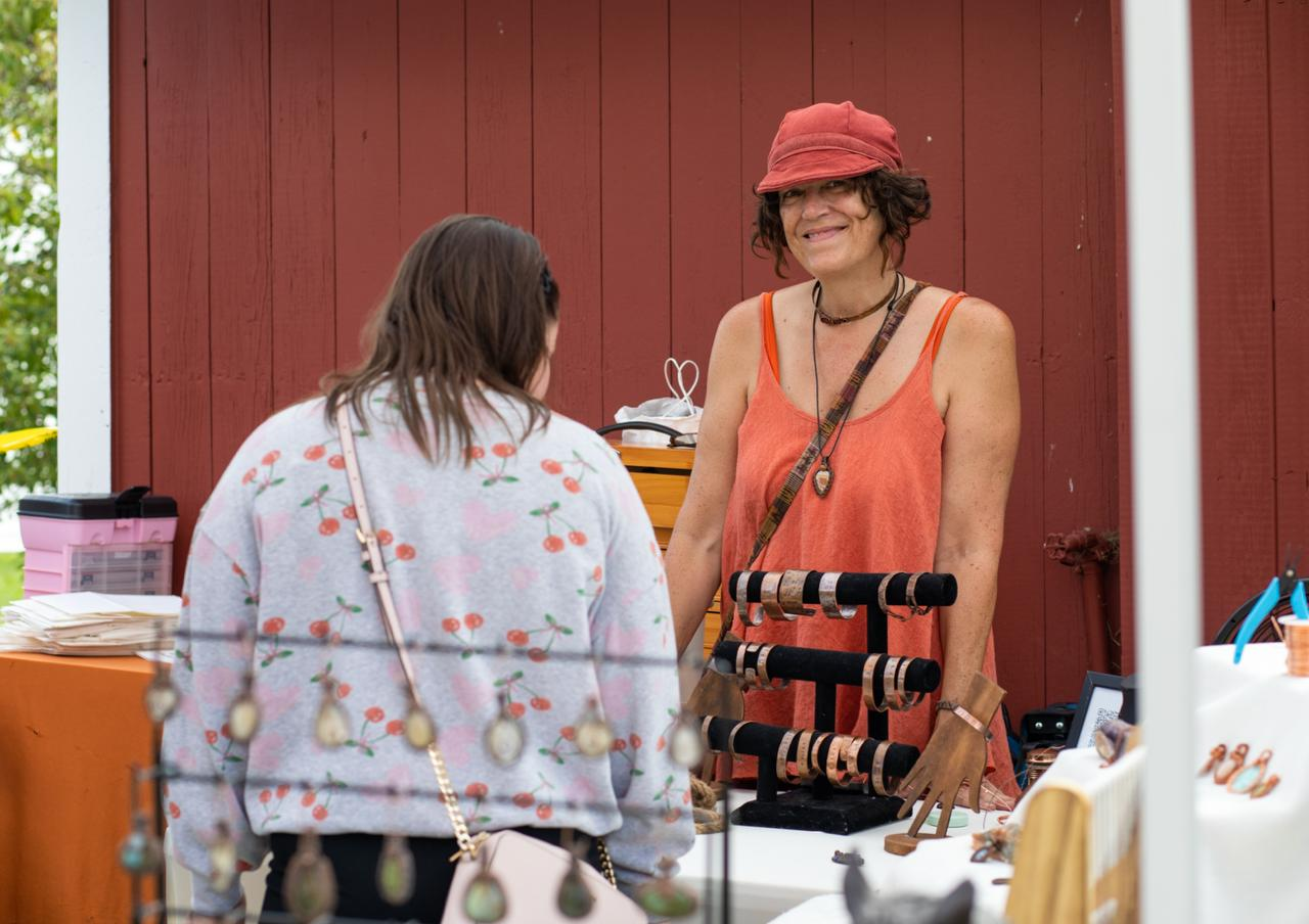 Tammy talking with a customer at her craft fair booth
